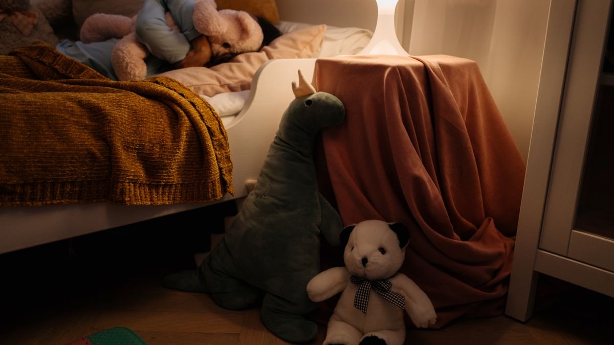 A warm and cozy child's bedroom setting with plush toys and soft lighting creating a peaceful ambiance.