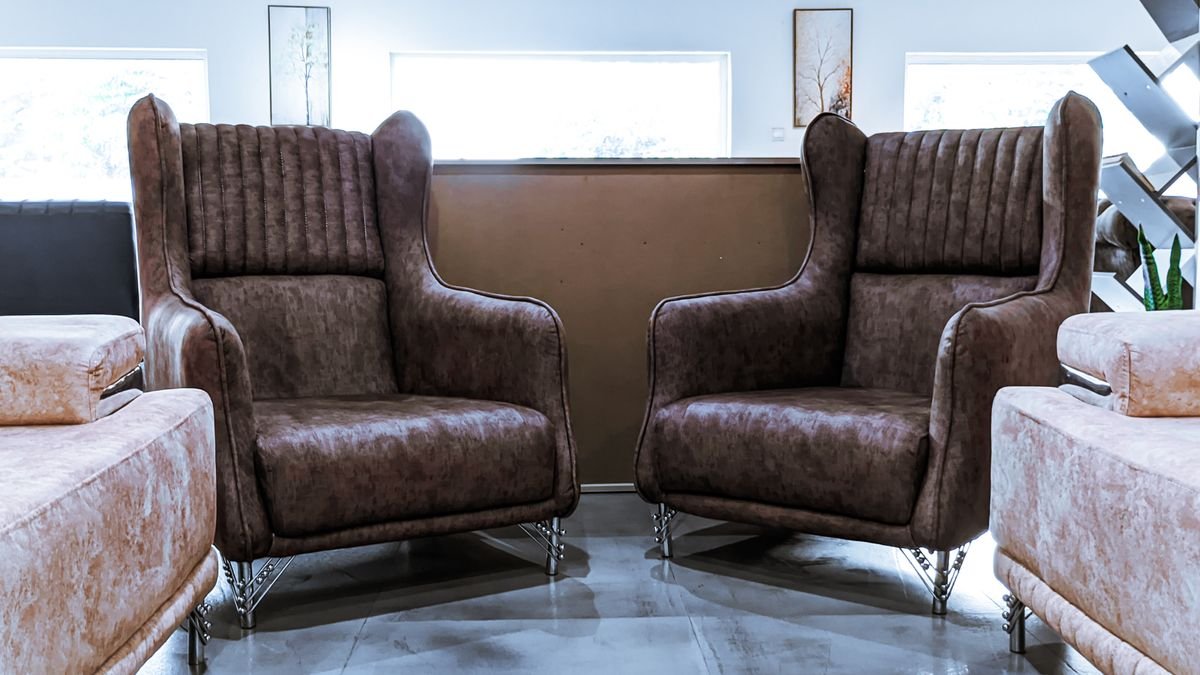 Stylish brown leather armchairs in a modern lounge interior, perfect for relaxation and comfort.